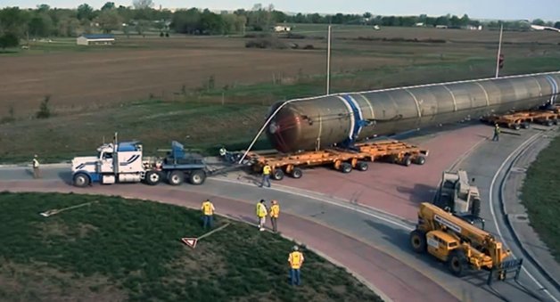 Watch the Slow and Careful Process of an Oversize Load Truck Negotiating a Roundabout