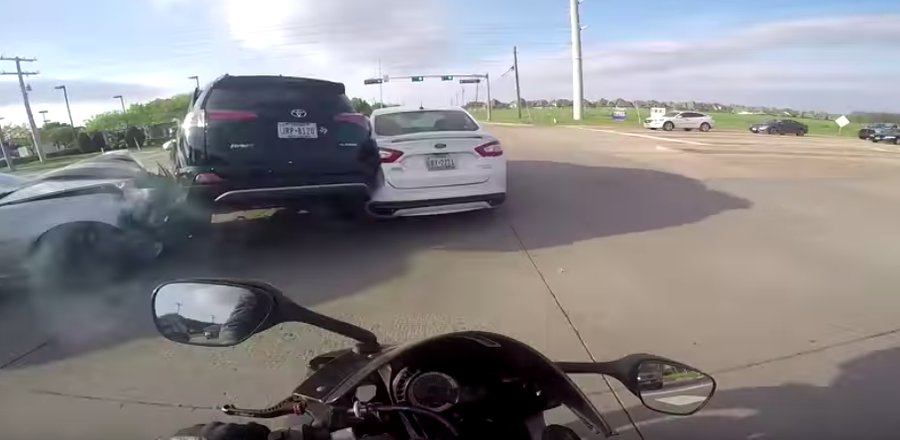 Motorcyclist rides underside of SUV out of T-bone crash
