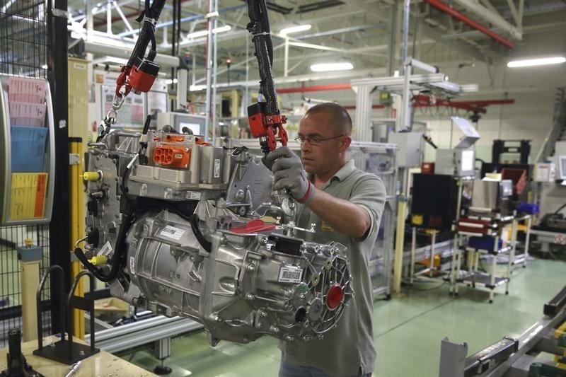 A employee handles the new R240 electric engine by French carmaker Renault for their Zoe model autom