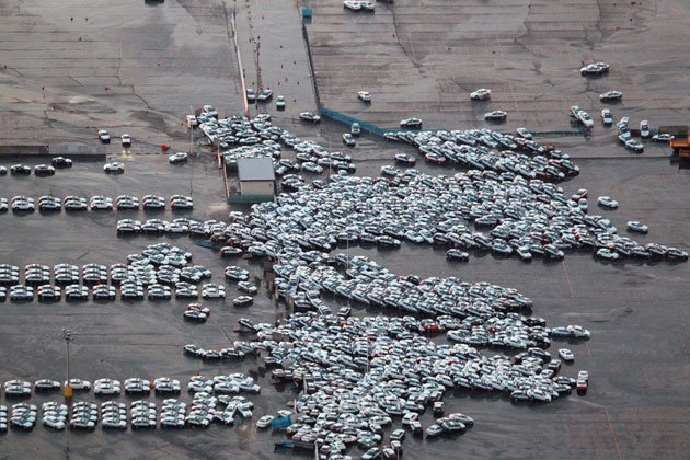 Tsunami in Japan destroys mass of cars ready for shipping