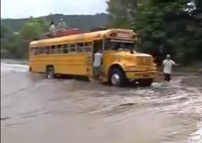A Nicaraguan school bus with children crosses a raging river and makes a return trip