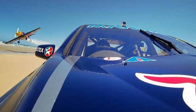 Red Bull Pits V8 Supercar Against Stunt Plane... on a Beach