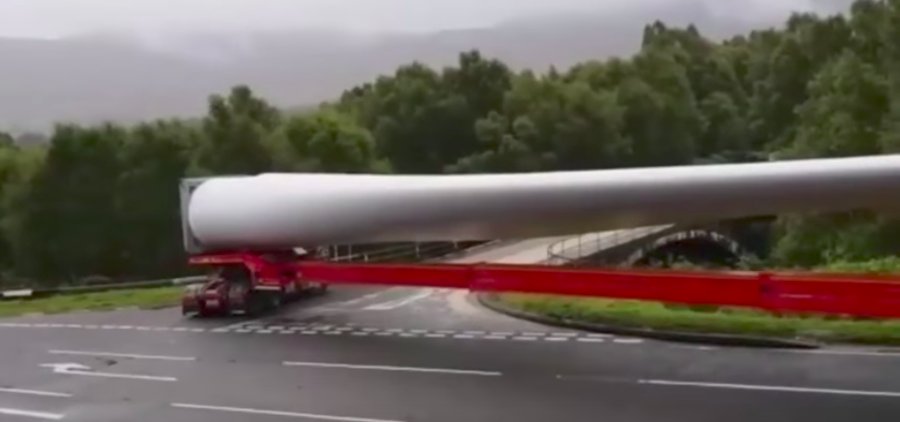 Blade of glory! Incredible video shows how lorry carrying a 200-FOOT wind turbine part manages to take a sharp right turn on a narrow Highland road