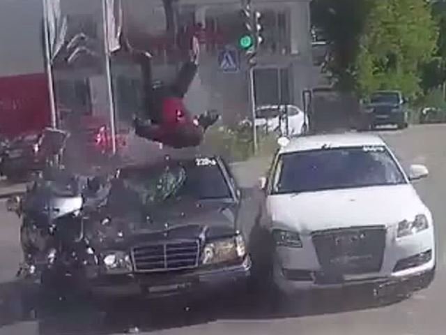 Biker Lands Between Two Crashing Cars