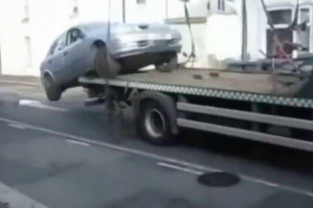 Watch as Upset Motorist Drives Off Flatbed Truck to Avoid Parking Ticket