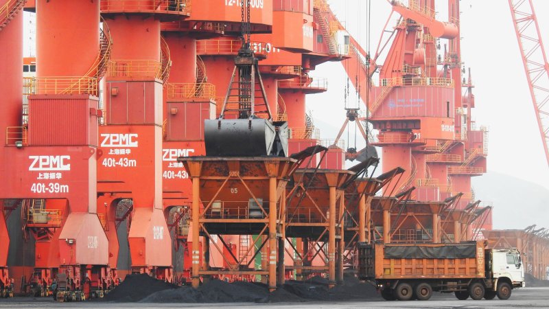 An electric cargo ship is delivering coal in China