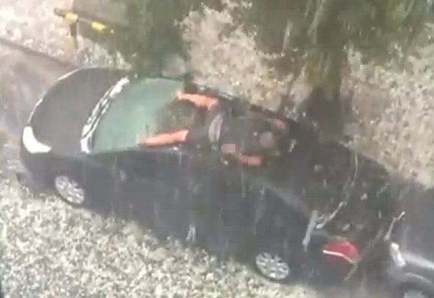 Video: Man Desperately Trying to Protect Car from Hail