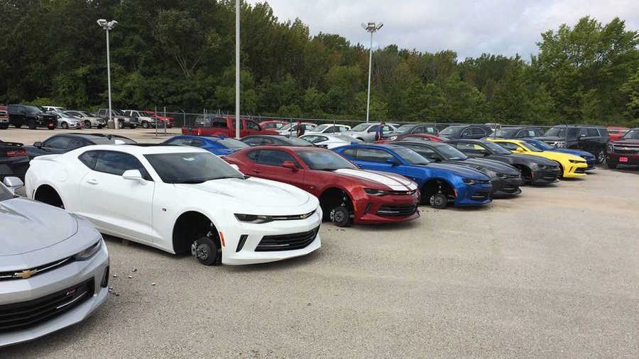 Police say wheels were stolen from 48 cars at a Texas dealership.