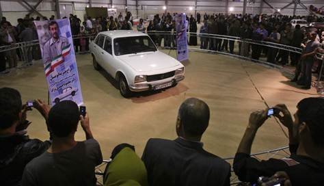 Iranians take photographs of Iranian President Mahmoud Ahmadinejad's car
