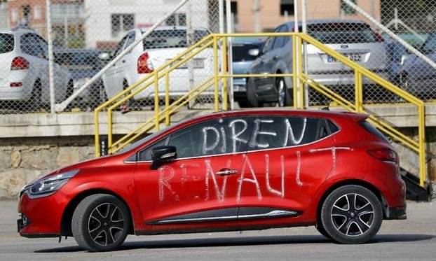 A slogan on a car in front of the Renault's Bursa factory reads "Resist Renault.”