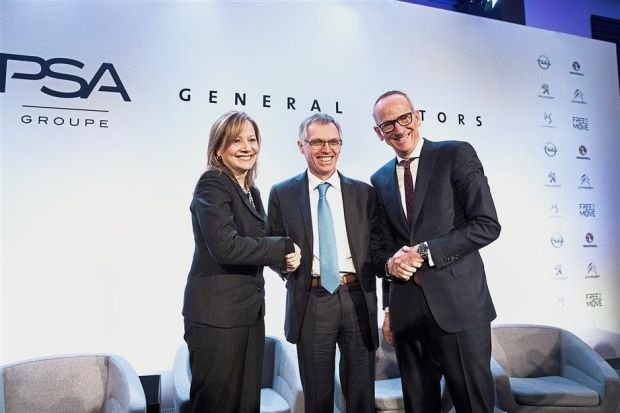 Tavares (centre) shakes hands with Mary Barra and Karl-Thomas Neumann, CEO Adam Opel AG