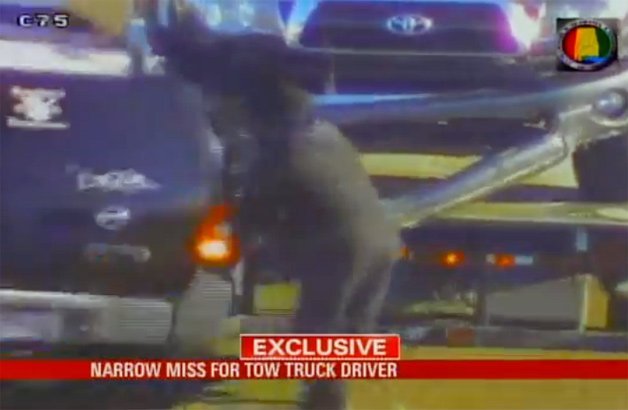 Watch This Lucky Tow Truck Driver Escape a Sliding Car