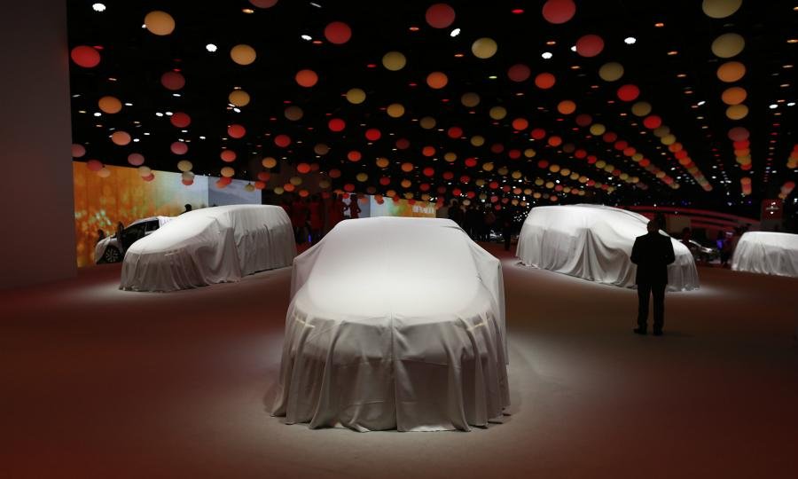 Cars are pictured ahead of their unveiling at the Paris auto show in 2014
