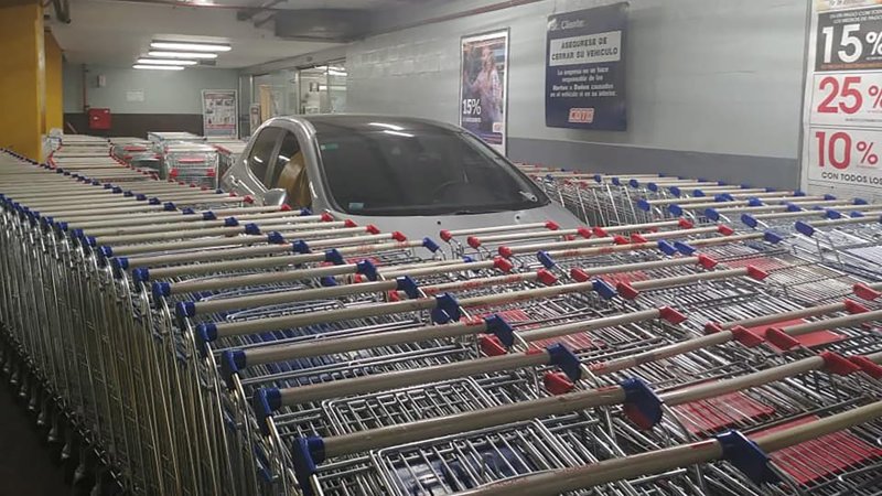 Supermarket employees bury improperly parked car in shopping carts